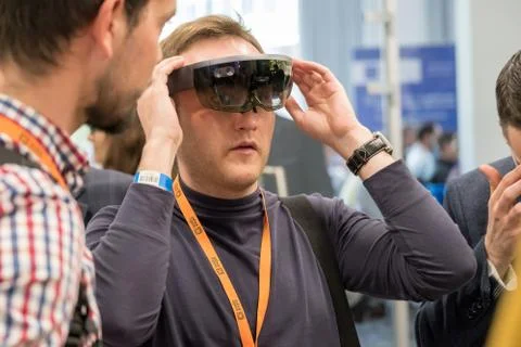Young man testing hololens VR glasses at VR conference Stock Photos