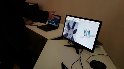 Young man is testing the pc software for modeling space satellites on laptop Stock Footage 73438575