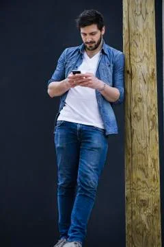 Young man text messaging on cell phone Stock Photos