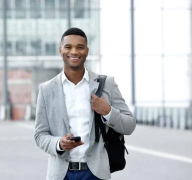 Young man text messaging on mobile phone Stock Photos