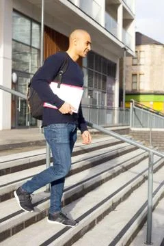 Young man with textbooks and a rucksack Stock Photos