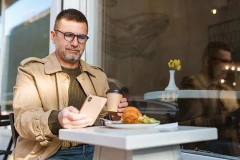 Young man texting message on smart phone Stock Photos