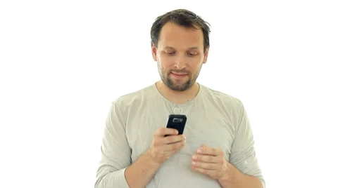 Young man texting, sending sms and smiling, isolated on white HD Stock Footage 8553390
