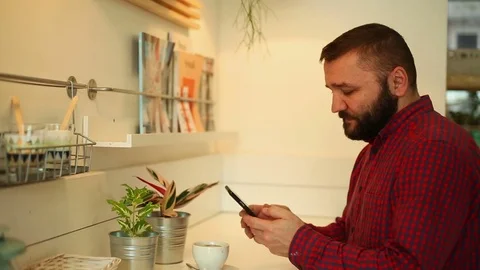 Young man texting, sending sms on smartphone in cafe, close Stock Footage 70859119