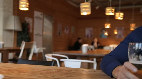 Young man texting on smartphone and drinking beer in cafe Stock Footage 67861468