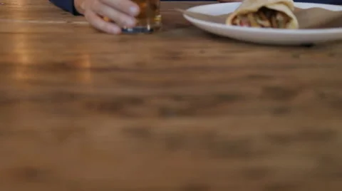 Young man texting on smartphone and drinking beer in cafe Stock Footage 67861499