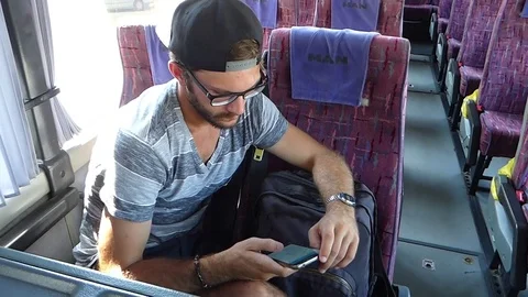 Young man texting on a smartphone in a bus 2 Stock Footage 85072048