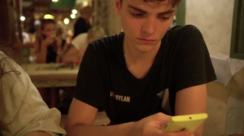 Young man texting on smartphone in cafe Stock-Footage 69029710