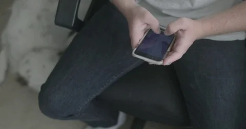 Young man texts on smart phone Stock Footage 78037451