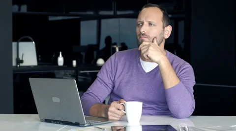 Young man thinking about resolution in the kitchen Stock Footage 66768441