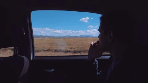Young man thinking and looking outside to view a nature scene Stock Footage 92206338