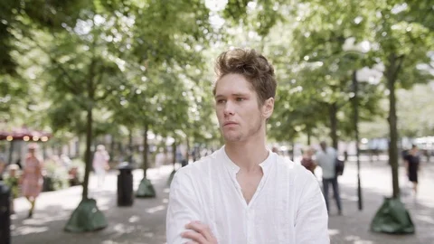 A young man thinking and looking concerned in Stockholm City park. Stock Footage 115922888