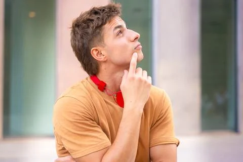 Young Man Thinking and Looking to the Side Stock-Fotos