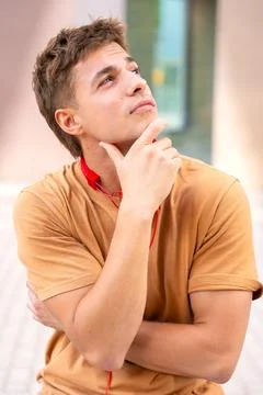 Young Man Thinking and Looking to the Side.Vertical Stock Photos