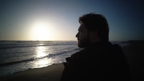 Young man thinking on beach Stock Footage 277516576