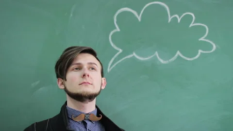 Young man thinking on a chalk-chalked background on a blackboard Stock Footage 88193161