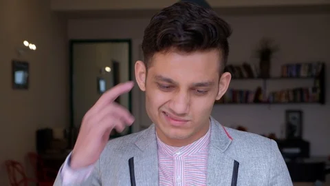 Young man thinking making faces scratching his head as he tries to understand an Stock Footage 101286926