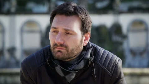 A young man thinking in the park and looking around Stock Footage 102280749