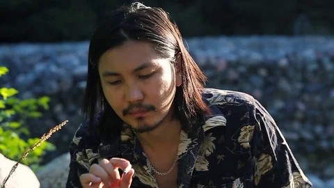 Young man thinking to quit smoking, slow motion Stock Footage 76009461