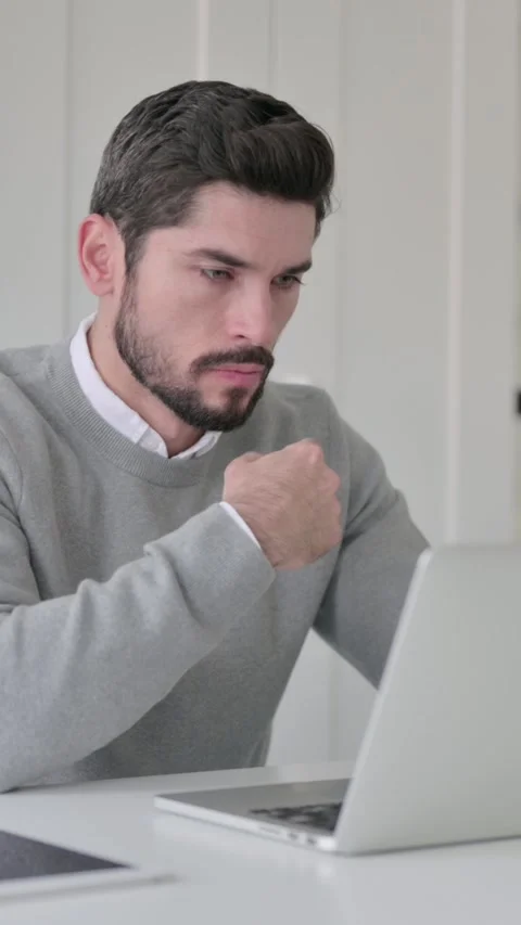 Young Man Thinking while Working on Laptop in Office, Vertical Video Stock Footage 339581858