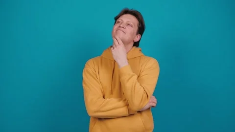 Young man thinks deeply about something tries to make decision in mind Stock Footage 263293434