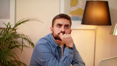 Young Man Thoughtful Concerned Working on Laptop Computer Looking Away Thinking Stock Footage 147004649