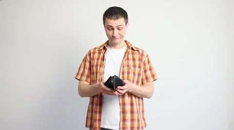 Young man throwing away an empty purse Stock Footage 60408236