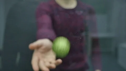 Young man throwing a ball into glass whiteboard Stock Footage 84980258