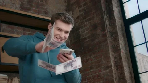 Young man throwing money at camera Stock Footage 160034692