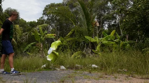 Young Man Throwing Rubbish in Forest. Stock Footage 40682370