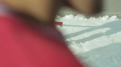 Young man throwing snow shovel Stock Footage 64043645