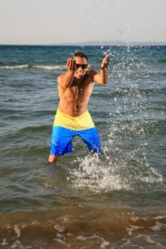 Young man throwing water Stock Photos