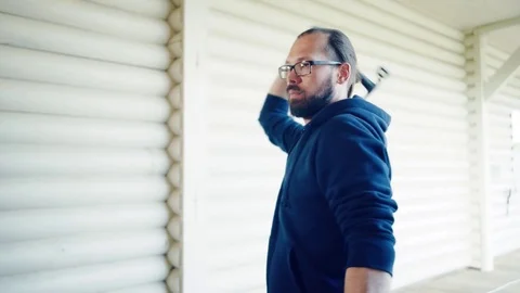 Young man throws axes Stock Footage 81922899