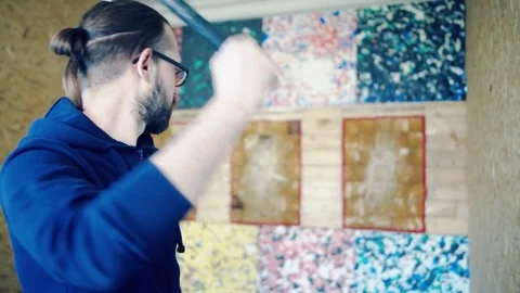 Young man throws axes at the target Stock Footage 81923396