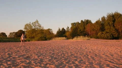 A young man throws a frisbee to aussie. An Australian Shepherd with complete Stock Footage 204984504