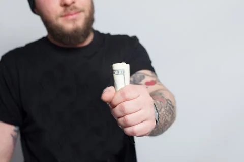 Young man throws money to camera. Stock Photos