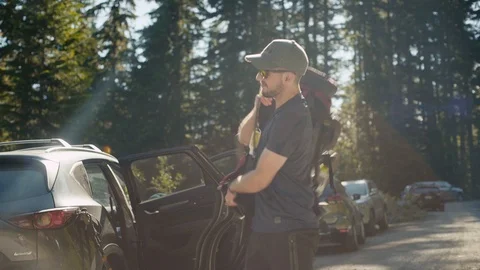 A young man throws an overnight pack over his shoulder Stock Footage 93210698