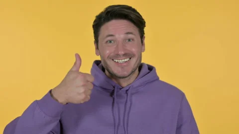 Young Man with Thumbs Up, Yellow Background 스톡 동영상 141671741