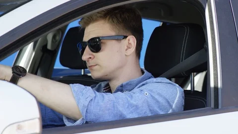 Young man is tired in a traffic jam. He puts his head on a steering wheel Stock Footage 124518918