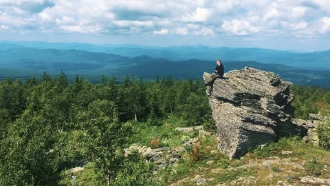 Young man on the top of the mountain Stock Footage 93856436