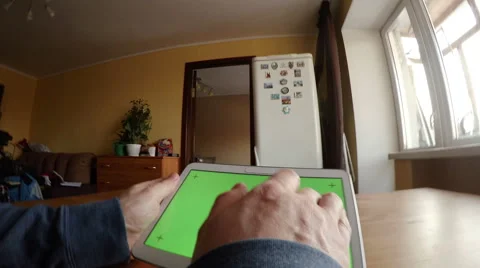 Young man touches a tablet PC. A camera is on a hand Видео 60571622