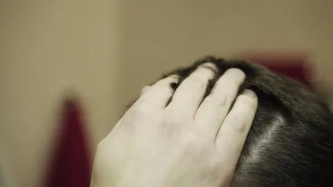 Young man touching and checking head worried about dandruff. Haircare concept Stock Photos