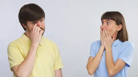 Young man touching his eye with dirty finger and young woman looking surprised Stock Footage 127104266