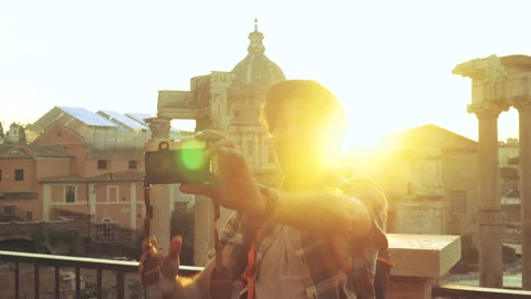 Young man tourist backpacker taking selfies with vintage camera at Roman Forum Stock Footage 238479664