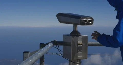 Young man tourist looking through coin operated telescope Stock Footage 74107686