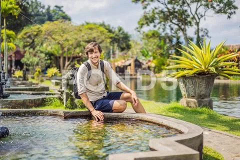 Young man tourist in Taman Tirtagangga, Water palace, Water park, Bali Indonesia Stock Photos