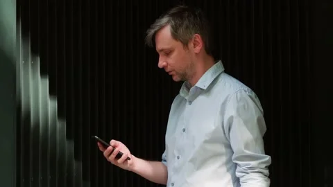 Young man tourist using smartphone close-up, businessman writing message in Stock Footage 197079809