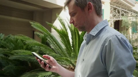 Young man tourist using smartphone close-up, businessman writing message in Stock Footage 197191634