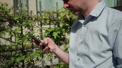Young man tourist using smartphone close-up, businessman writing message in Stock Footage 197373204