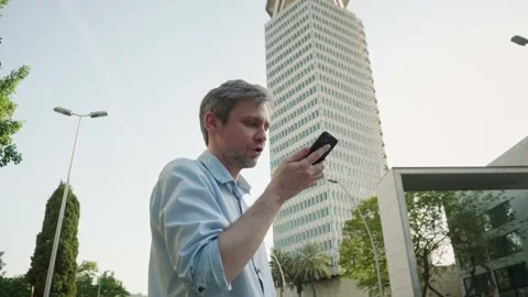 Young man tourist using smartphone close-up, businessman in headphones writing Stock Footage 207140882